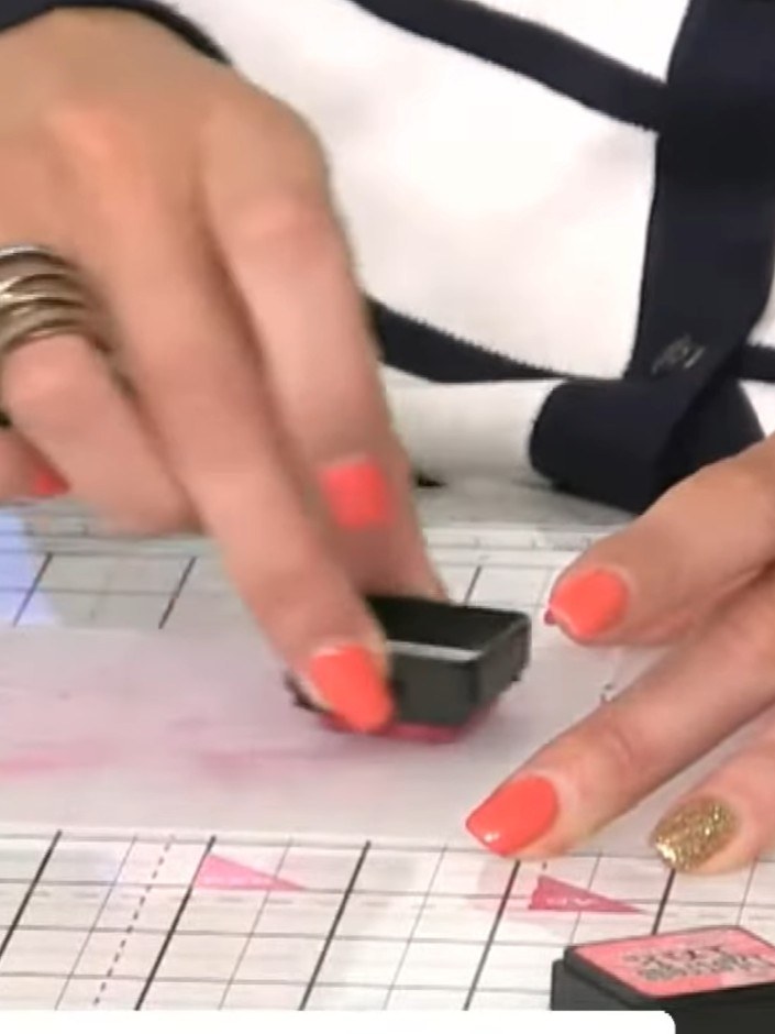 Step 6: Lightly spray the darker inked card with water. Run the sprayed card through the embossing machine to create t