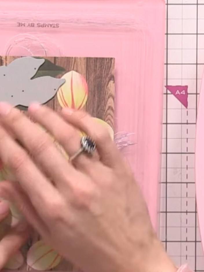 Step 2: Position the die-cut flower template onto the wood-effect panel, ensuring it aligns properly over the printed 