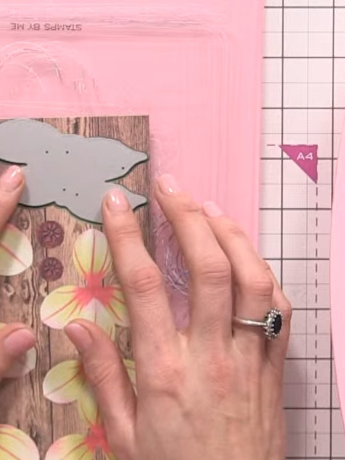 Step 4: Position the die plate on your chosen paper. Secure it in place using tape or hold it steady with your hands t