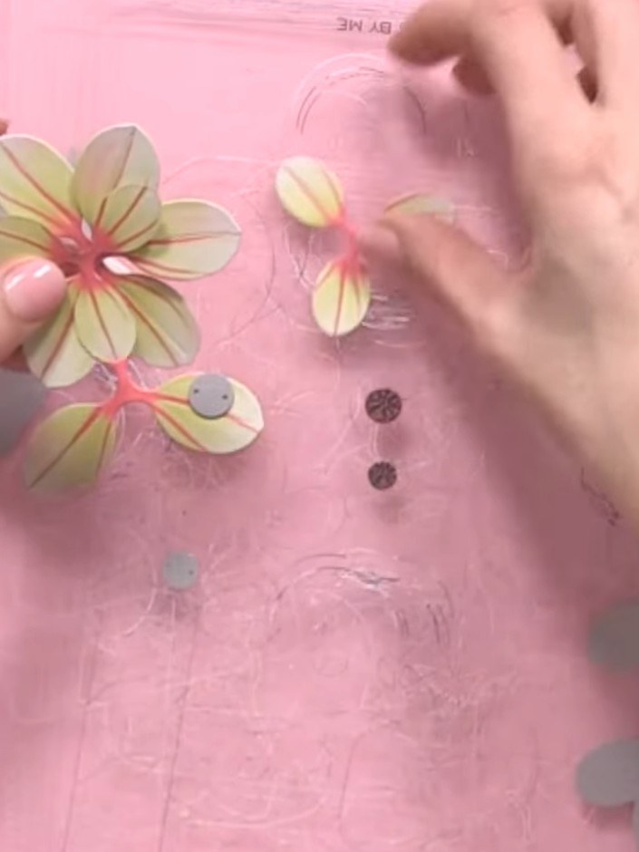 Step 8: Layer and offset the die-cut flowers on your pink card base, building your own unique bouquet arrangement. Pos