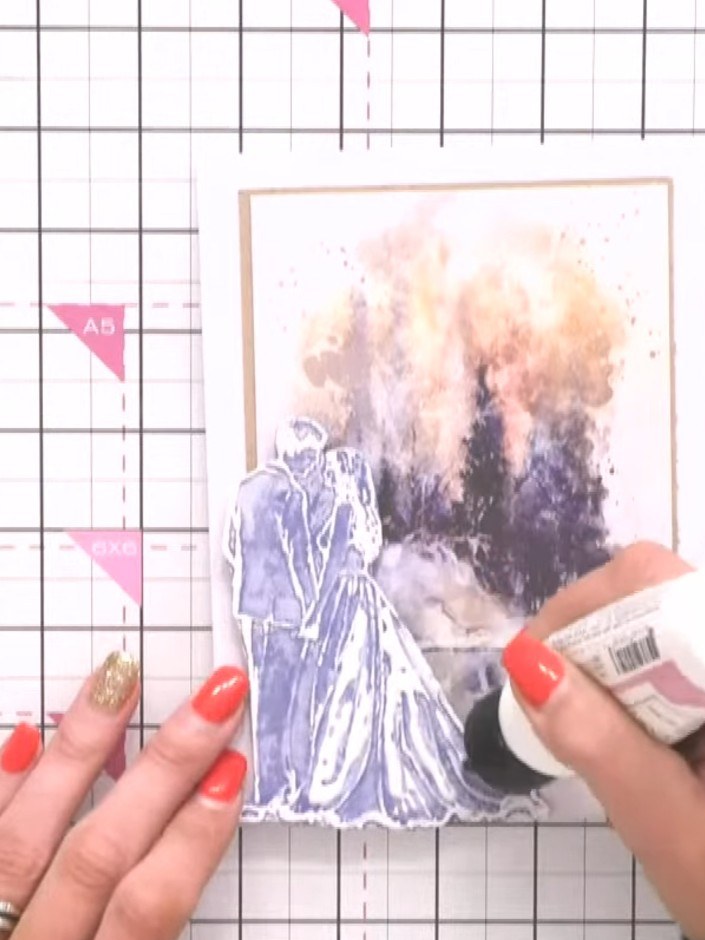 Step 3: Apply a dries-clear glue to the bride's gown area on the stamped design. Use a glue pen or applicator to caref
