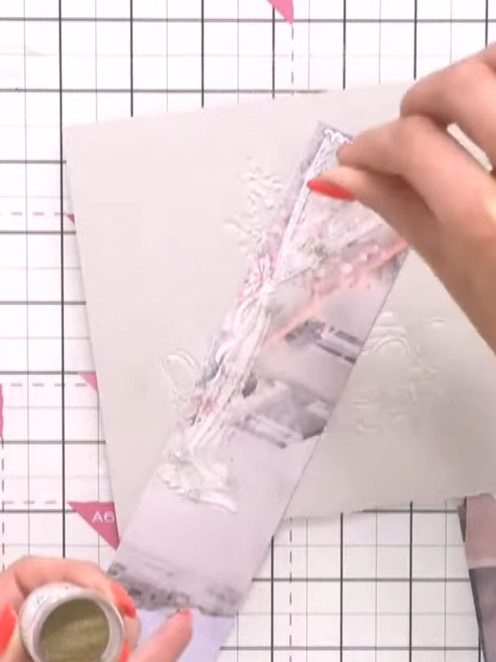 Step 6: Whilst the white ink is still wet, sprinkle gold embossing powder lightly over the curtain design on the card.