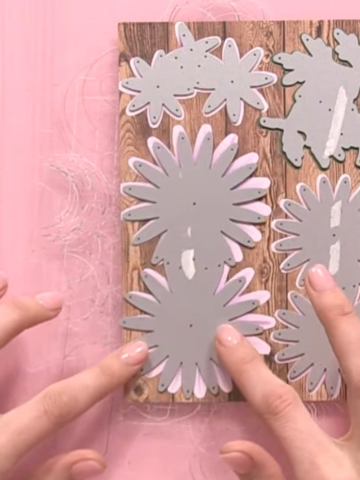 Step 3: If the die-cut flowers don't align properly with the white outlines on one side of the pink cardstock, flip th