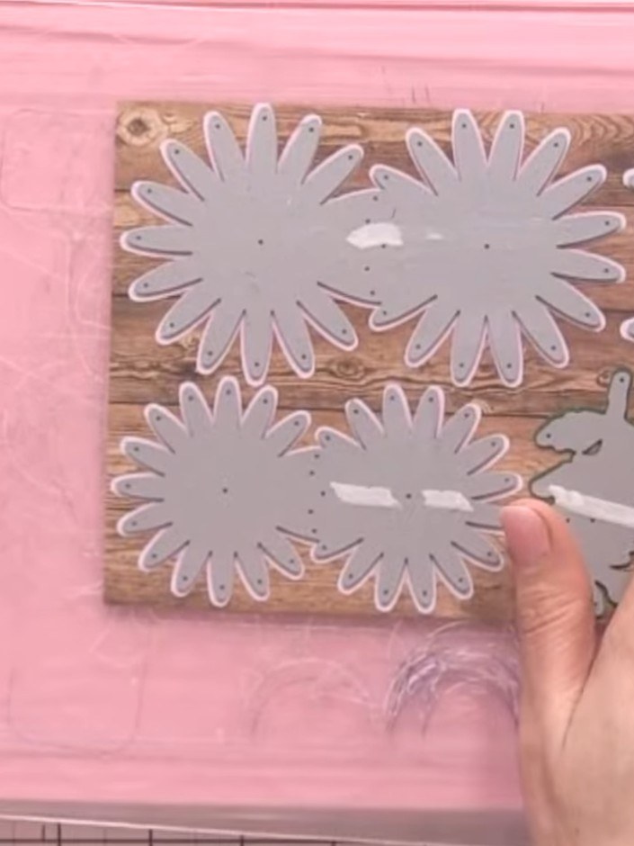 Step 6: Remove the die-cut flower pieces from the pink cardstock. Observe the embossed detail created by the die on th