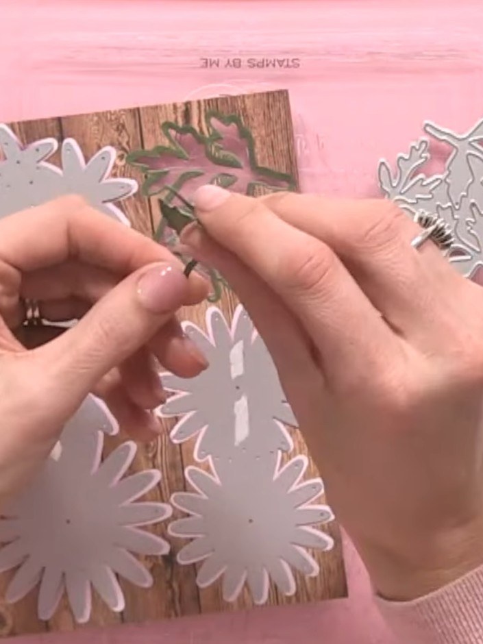 Step 8: Layer the die-cut chrysanthemum flowers onto your card base, offsetting them slightly to create depth and dime