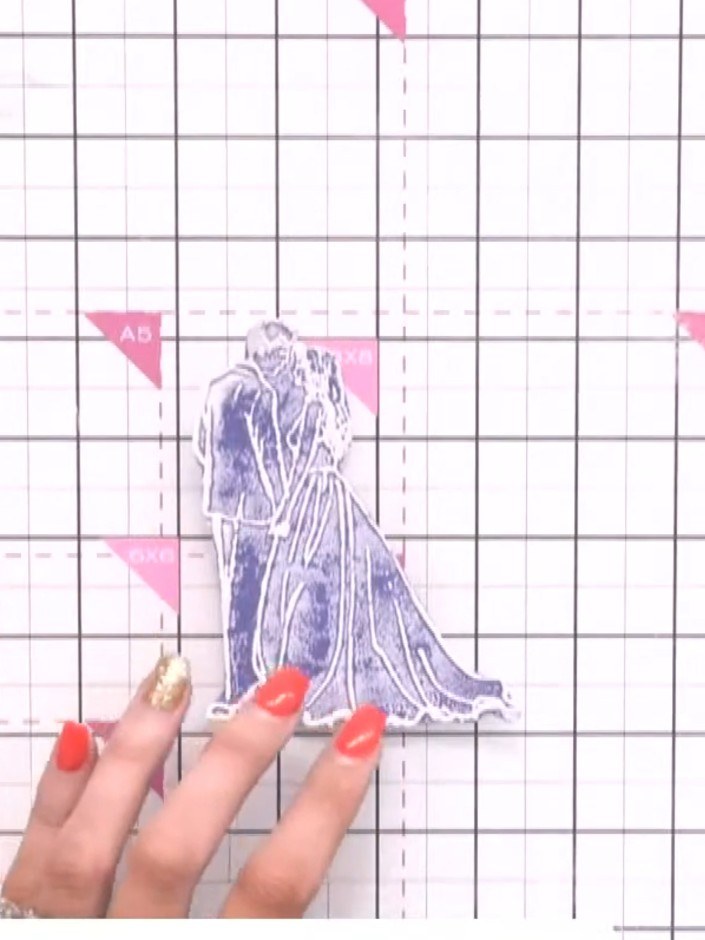 Step 6: Fussy cut around the bride and groom stamp, carefully cutting out the detailed outline of the figures.