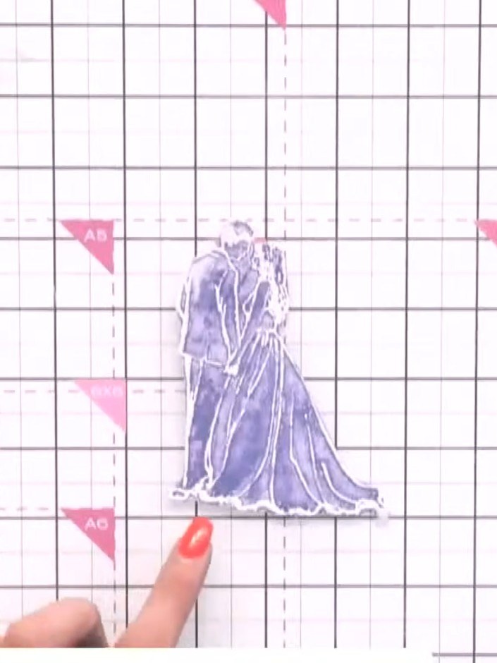 Step 8: Position the bride and groom stamps on top of the table setting design. Place them centrally to create a balan