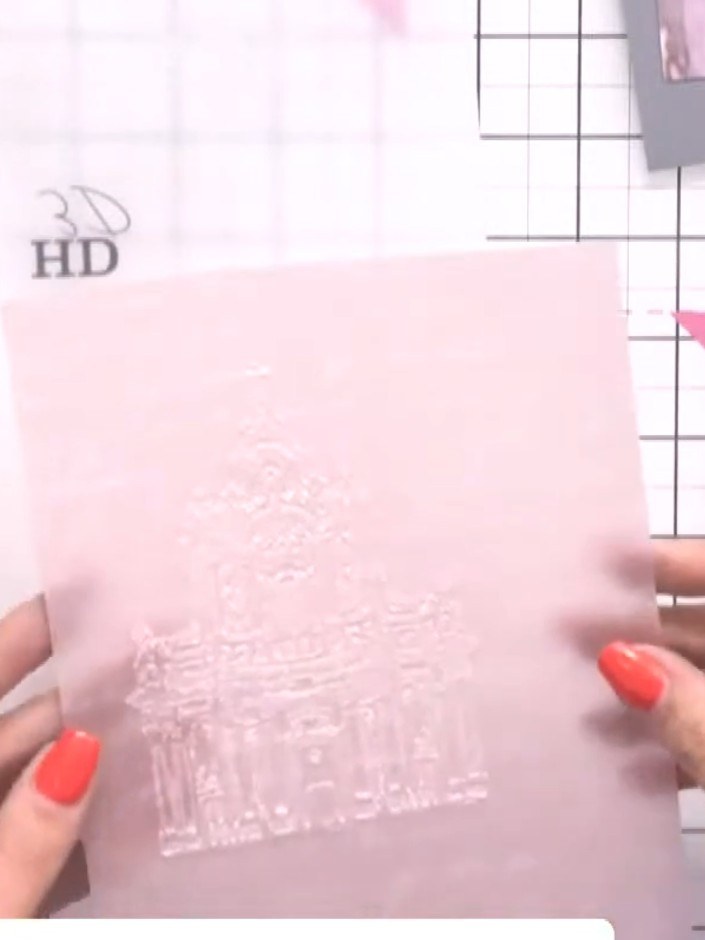 Step 1: Place the pink-toned vellum with script detail into the Abbey embossing folder.