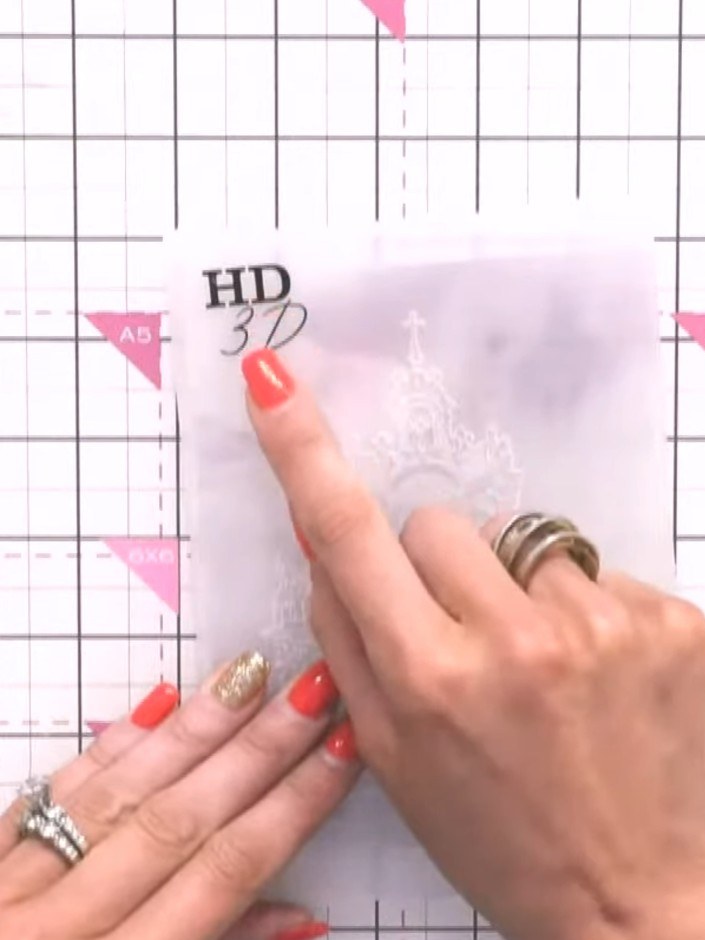 Step 1: Place a piece of vellum into the Abbey HD 3D embossing folder, lining it up carefully with the HD 3D marking o