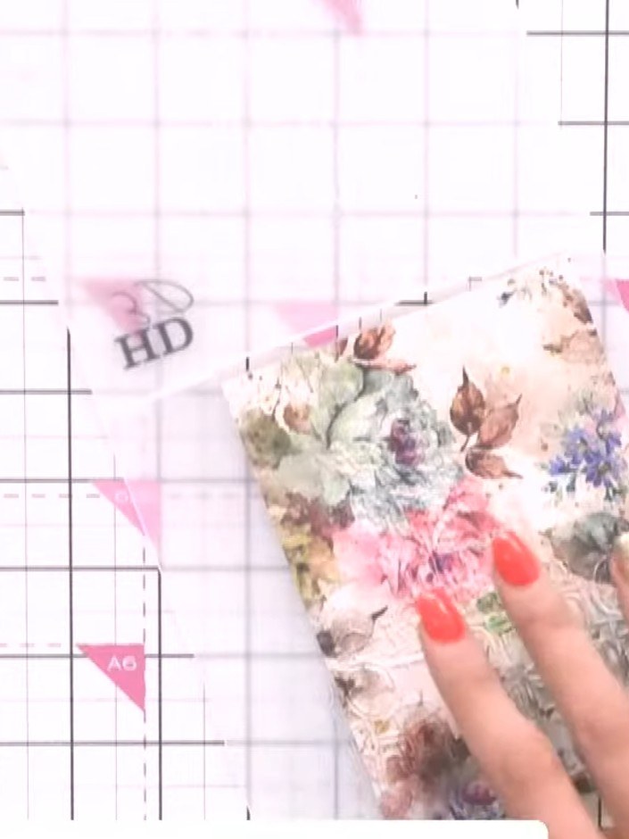 Step 4: Open the embossing folder to reveal the embossed design on the dark pink card. Note that the embossed pattern 