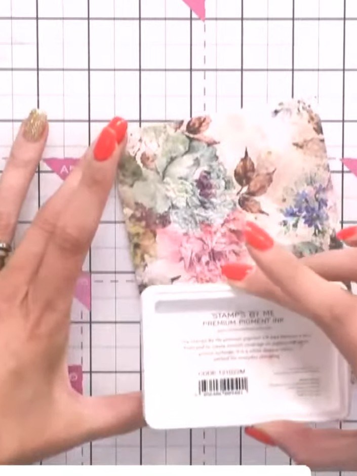 Step 5: Take a white ink pad and lightly swipe it across the embossed floral design to highlight the raised detail and