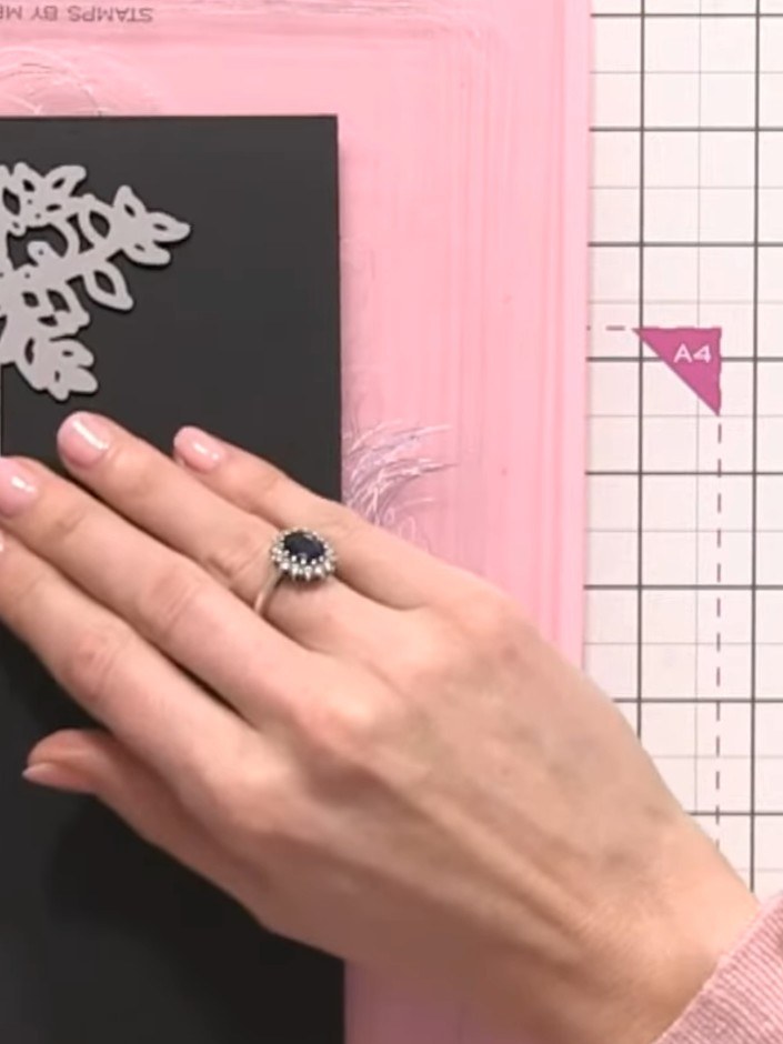 Step 4: Run the black cardstock with the floral banner die through your die-cutting machine to cut out the decorative 