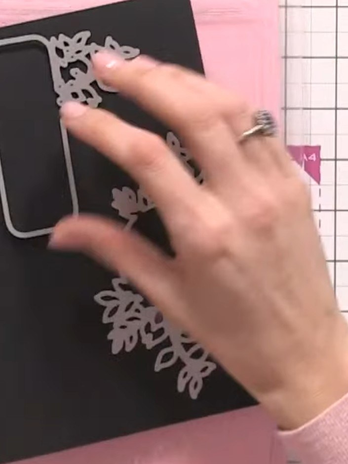 Step 7: Position the black banner piece onto your pink card base, ensuring it's centred as the focal point of your car