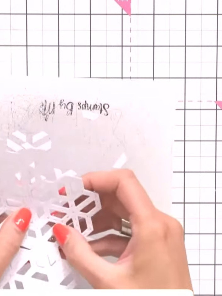 Step 3: Snip away sections of the white hexagon die cut to reduce bulk and create a custom shape. Remove segments to c