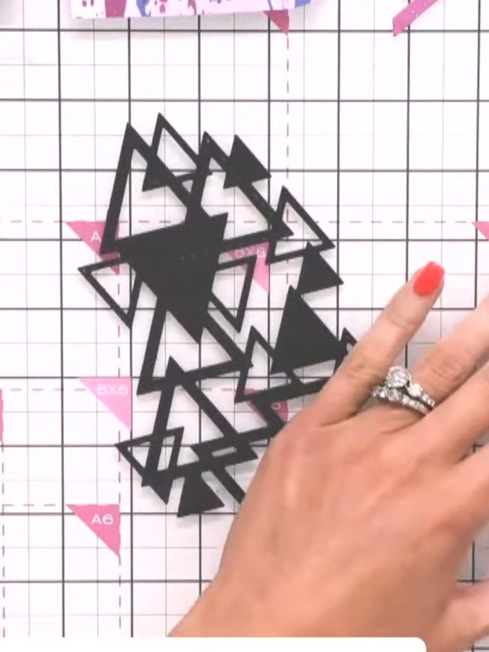 Step 5: Position the layered black triangle design onto the grey card blank. Use adhesive tape or glue to secure it fi