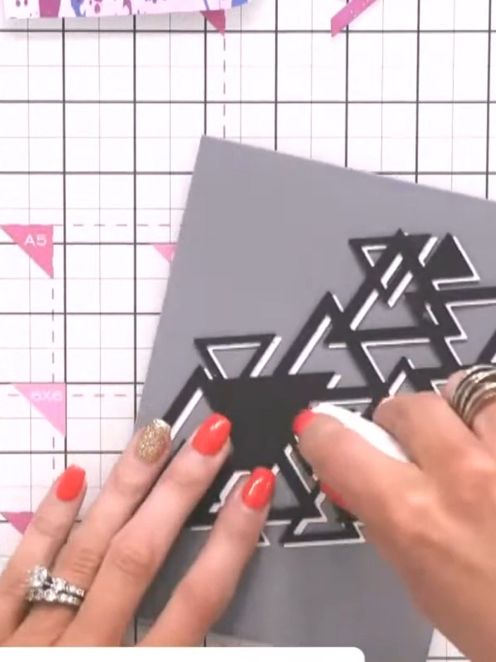 Step 6: Position the triangle design off to one side of the grey card base rather than centring it, creating an asymme