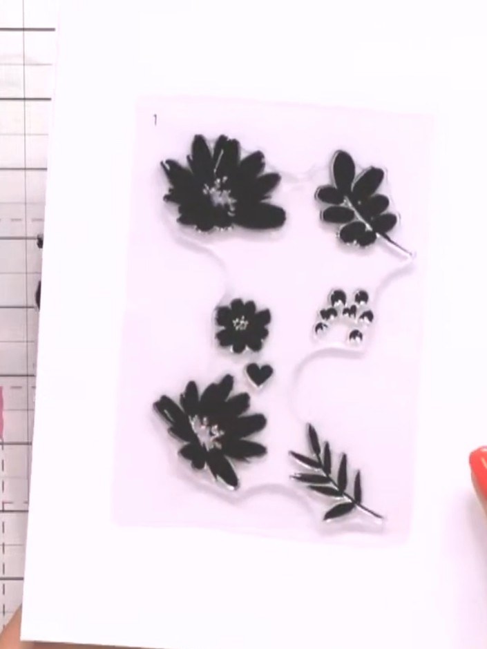 Step 1: Stamp the first layer of your chosen flower design onto white cardstock using black ink. The stamps are number