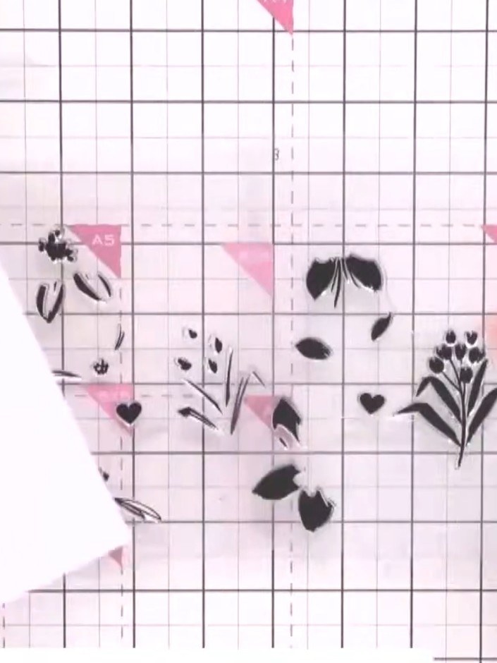 Step 2: Line up the second layer stamp by aligning the central heart guide with the first stamped image. Ink the stamp