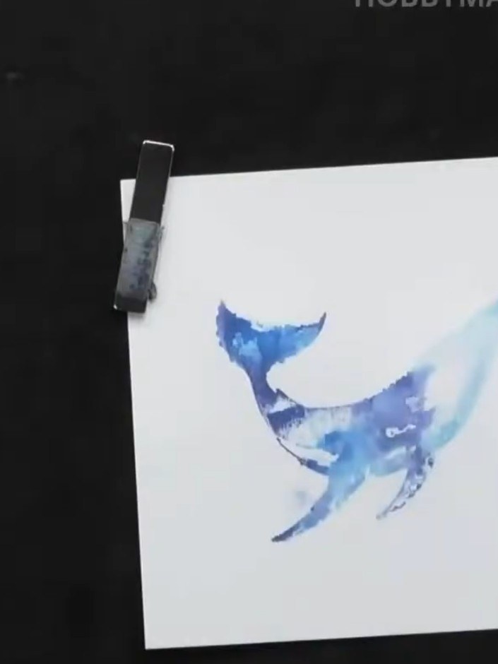Step 6: Stamp the wave stamps onto the black card using black ink. Re-ink the stamps and stamp again onto scrap paper 