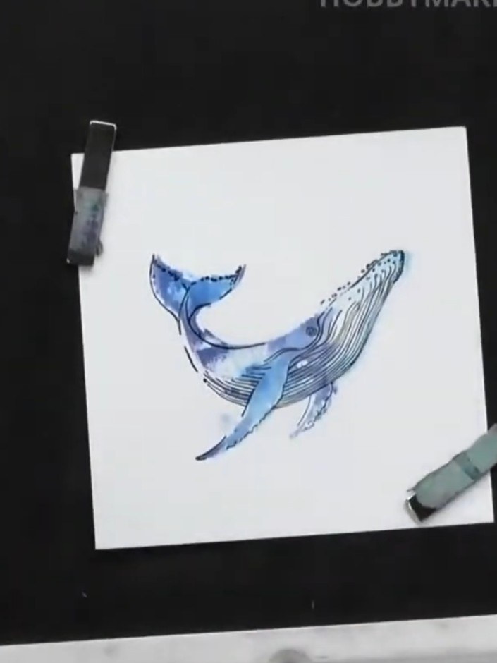 Step 7: Ink specific areas of your wave stamp to add spray effects and texture. Apply the ink to selected parts of the