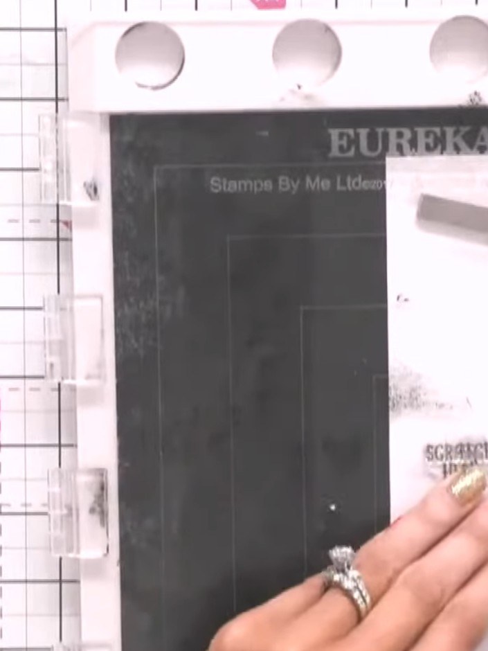 Step 1: Stamp the suitcase design from the Stamps By Me set in black ink onto white card. Position the stamp carefully