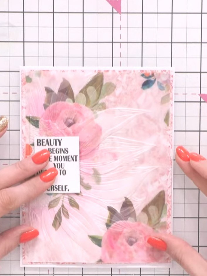 Step 10: Adhere the vellum layer with the sentiment to your pink floral cardstock base. Press gently across the surface