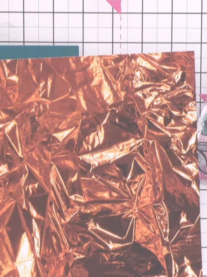 Step 1: Place your copper metallic patterned paper into the embossing folder, ensuring the rise is facing upwards for 