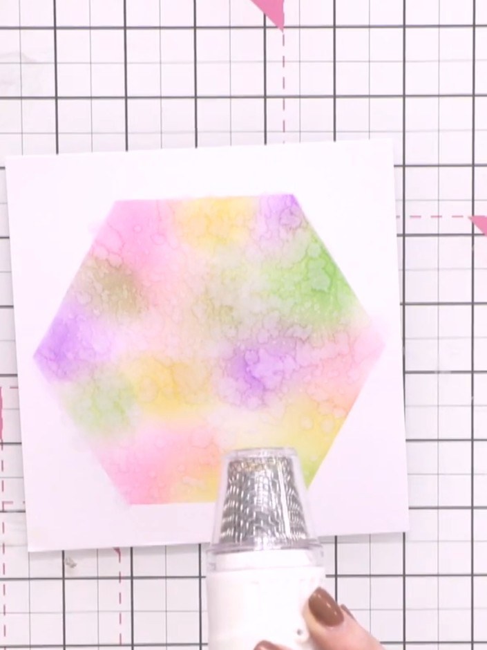 Step 5: Remove excess water from the stencilled card by blotting with tissue. Use a heat gun to dry the card thoroughl