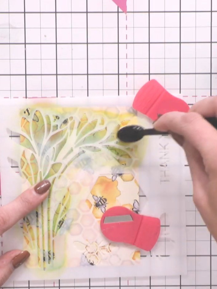 Step 7: Using a blending sponge, apply white ink to the highlights and edges of the yellow flower to create dimension 
