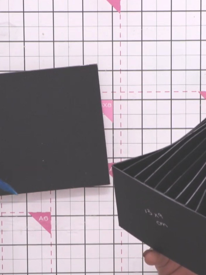 Step 10: Position the completed black album inside the black box lid, ensuring it sits centrally with even gaps on all 