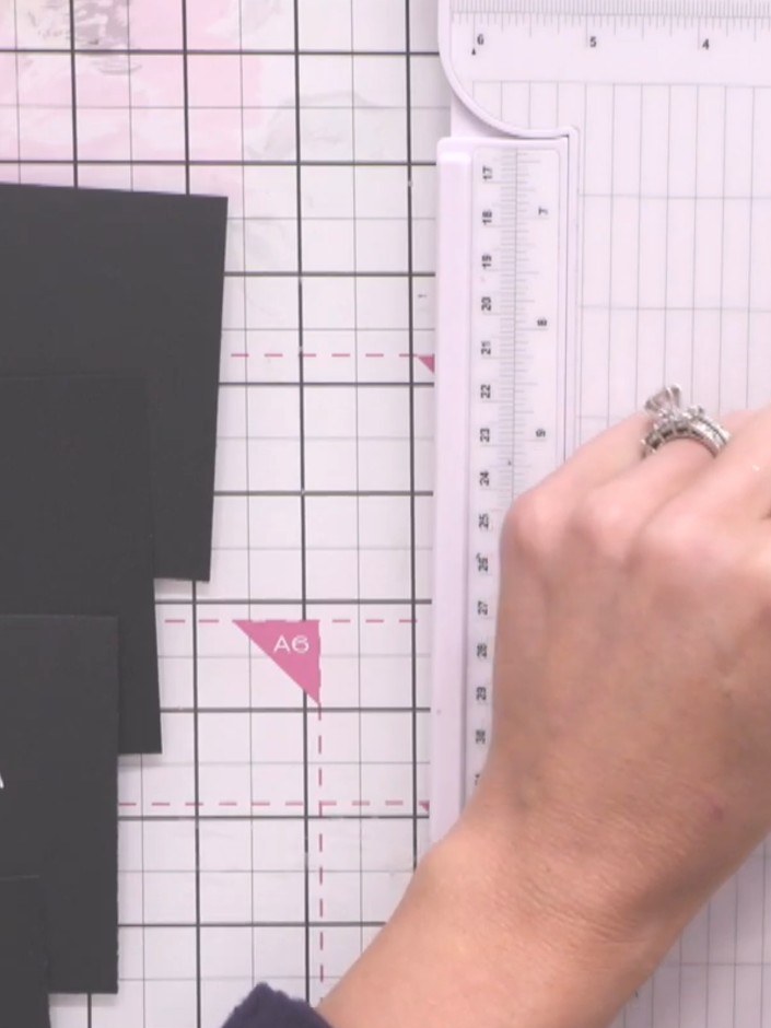 Step 3: Score the 13 x 9 cm black card piece 2 cm from both the left and right edges using your scoring tool and ruler