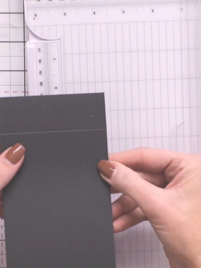 Step 6: Score each dark grey page 3.5cm from one end using your scoreboard. This creates a fold line that forms a buil