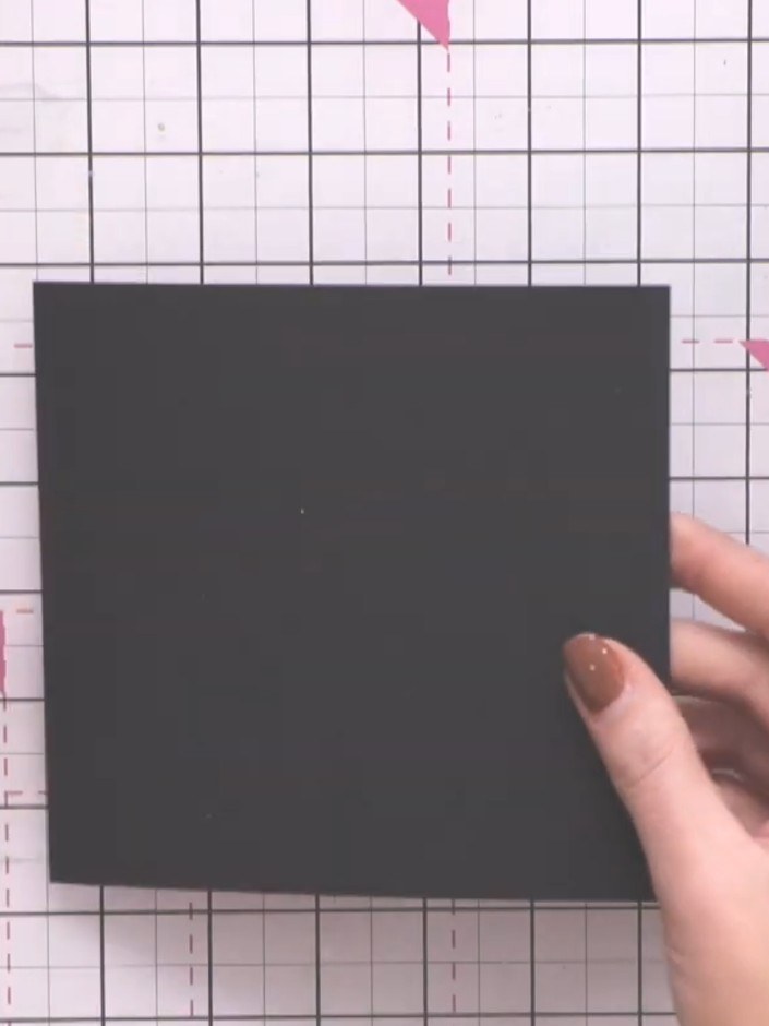 Step 9: Cut a piece of black card to approximately 10.75cm × 10.75cm to fit the inside of the lid. Glue the black card