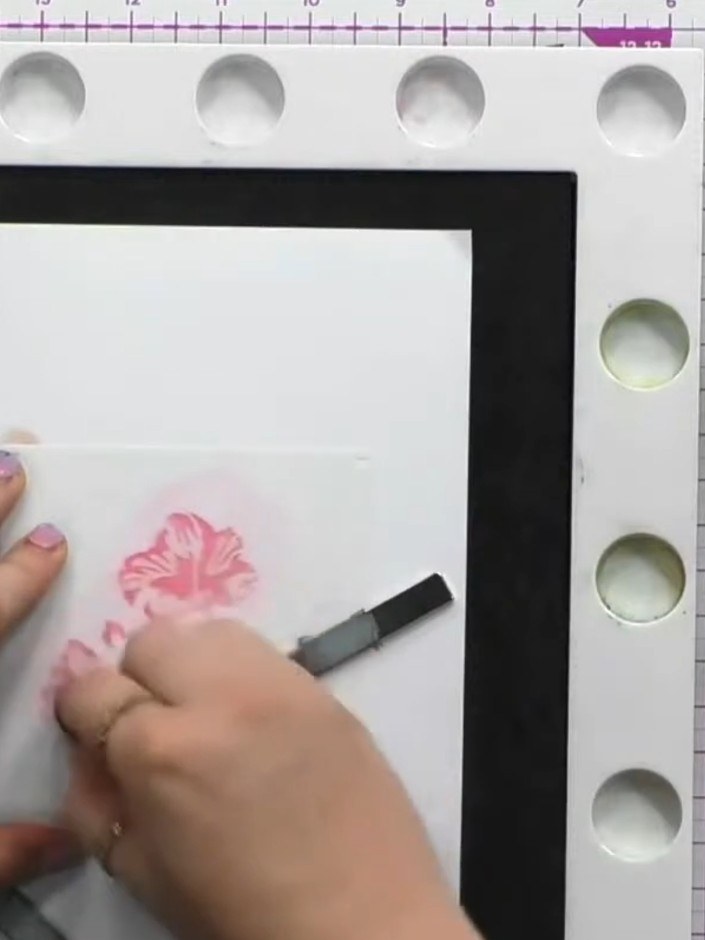 Step 4: Apply the third stencil using a darker pink ink pad to add depth and dimension to the hibiscus flower petals. 