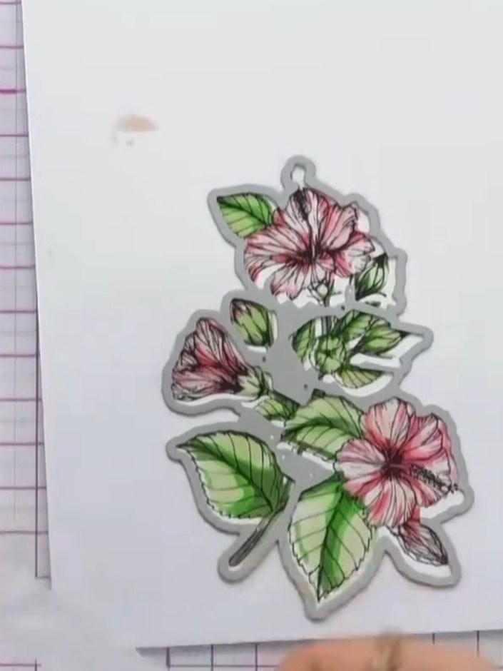 Step 7: Secure your stamped and stencilled hibiscus piece to your cutting mat with low-tack tape. Position the hibiscu