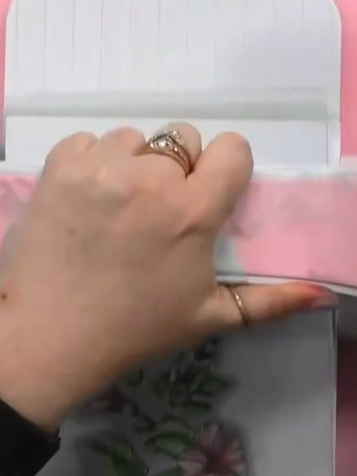 Step 8: Run the die-cutting machine to cut out your layered hibiscus image. The machine will cut through the stamped i