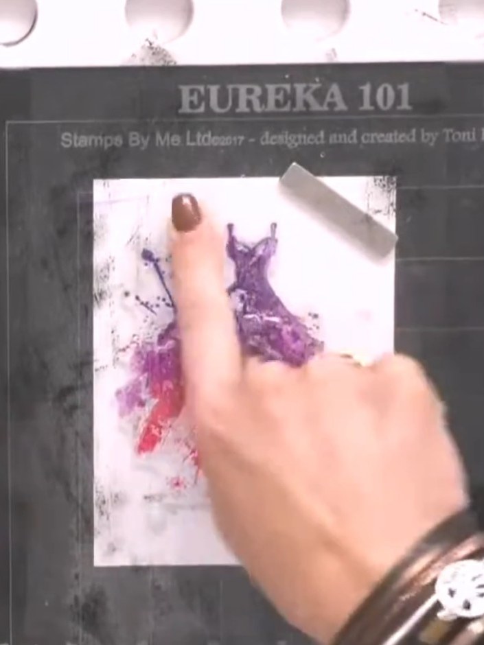 Step 4: Ink the detailed dress stamp with black ink. Carefully line up the straps of the stamp with the coloured water