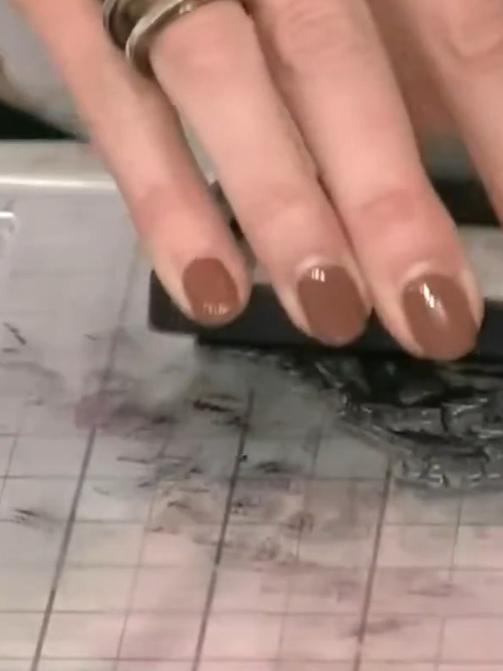 Step 8: Layer your stamped gown image on top of the embossed background, positioning it to create an attractive framin