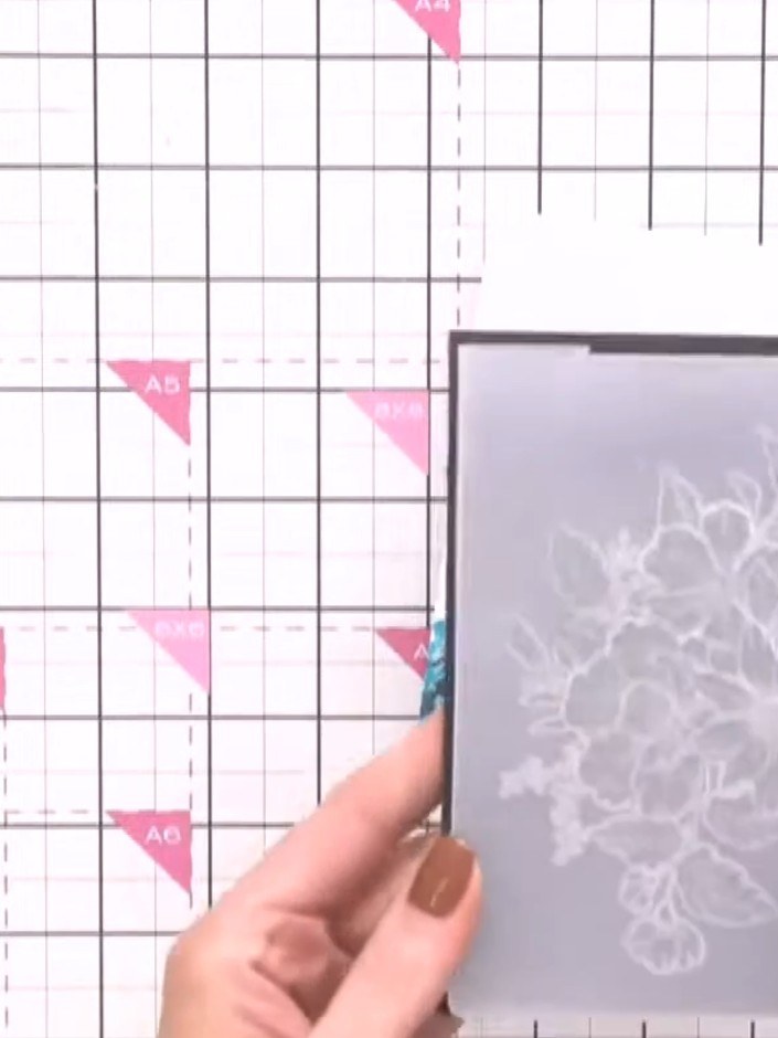 Step 1: Select your chosen embossing folder from the floral collection. Place a piece of decorative paper inside the e