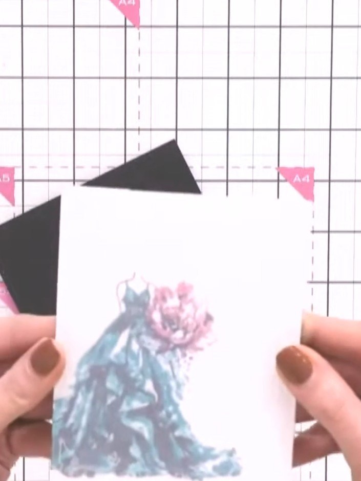 Step 2: Mount the embossed frame pieces onto your white card base, positioning them at the top corners to create a dec