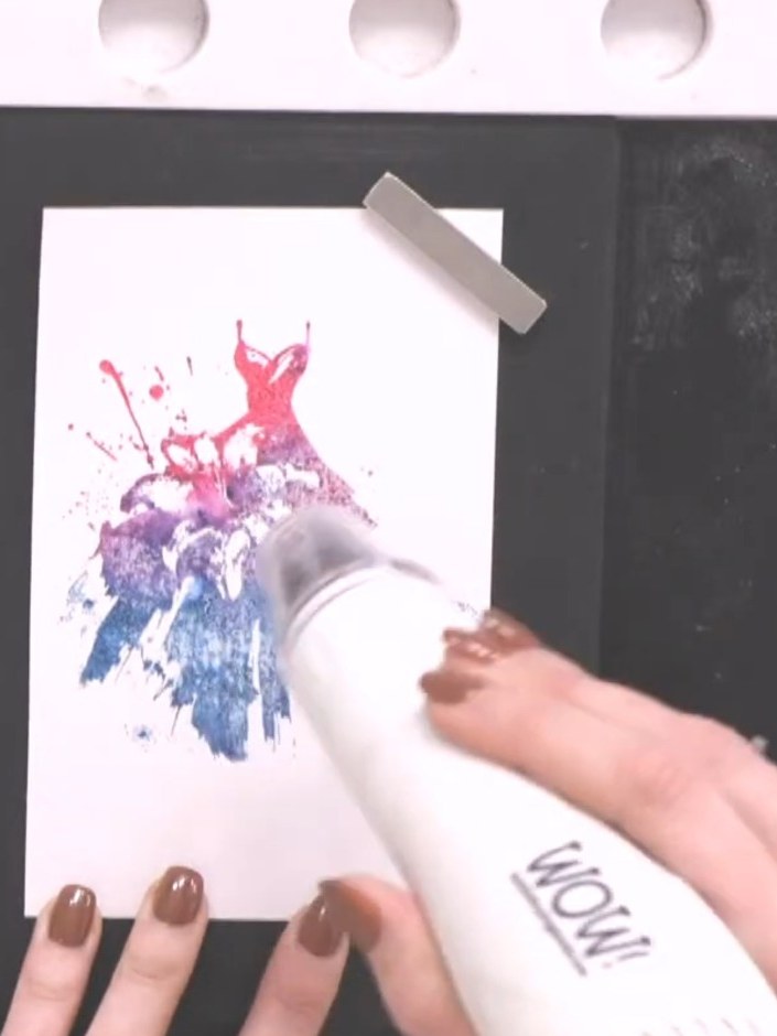 Step 7: Line up the detailed dress stamp and stamp it on top of the watercoloured image using black ink. This adds def