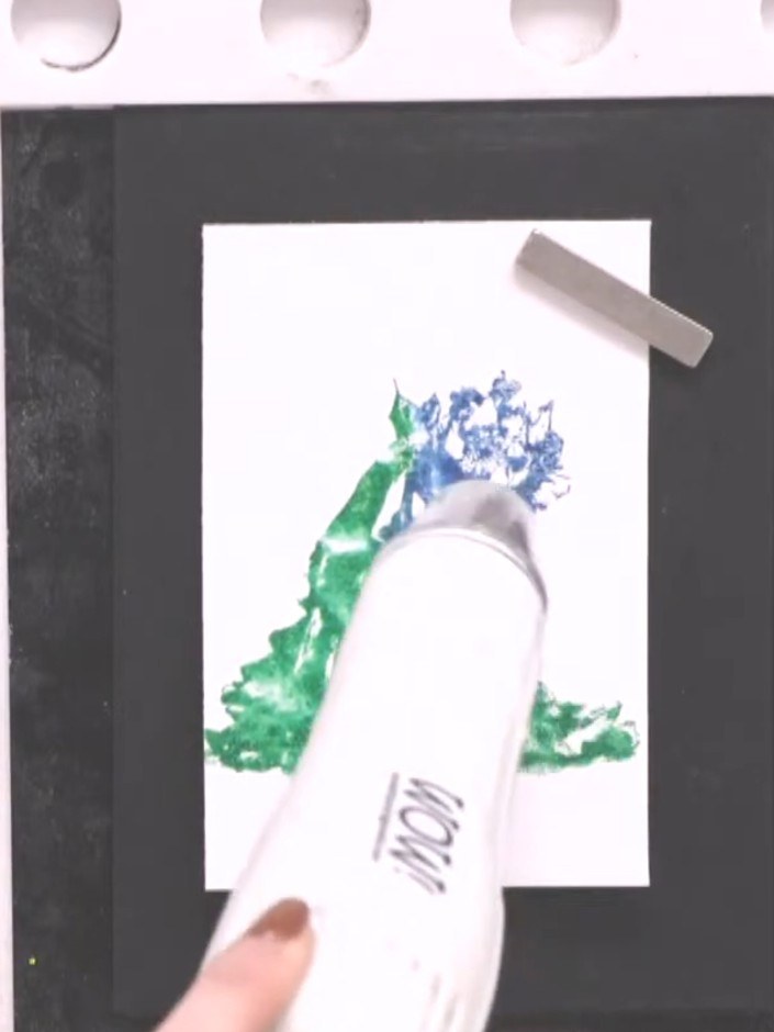 Step 7: Use a heat tool to dry the stamped image quickly. Stamp over the design multiple times to build up the colour 