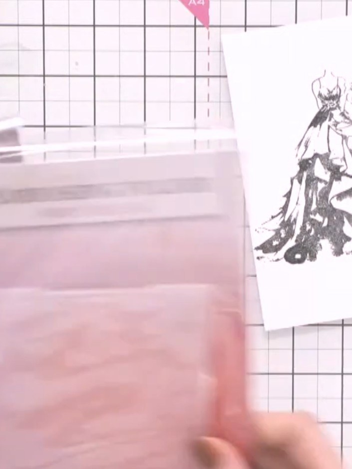 Step 3: Feed the stamped gown card through your embossing machine with the 3D embossing folder to create raised detail