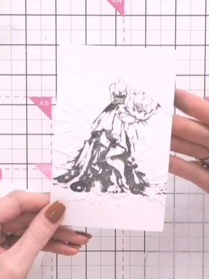 Step 6: Apply ink to the raised embossed areas of the stamped image to highlight the floral details. This brings the d