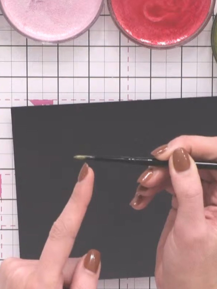 Step 3: Load your watercolour brush with green ink and paint leaves around the circle using the toe-belly-toe techniqu