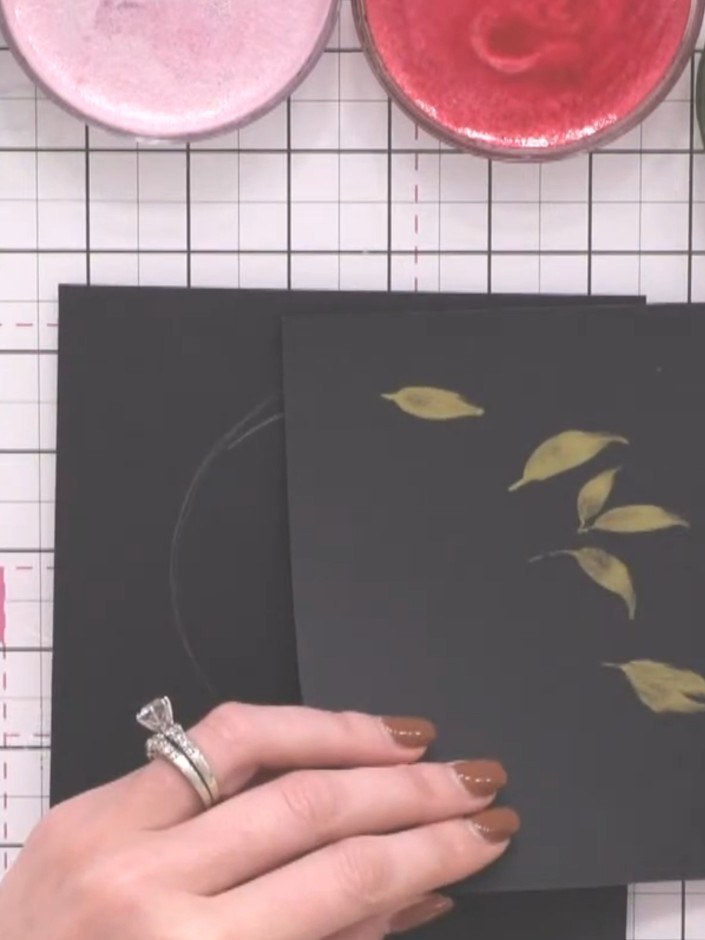 Step 5: Fill any gaps in the wreath with additional leaves using gold and green confetti ink. Layer the colours on top