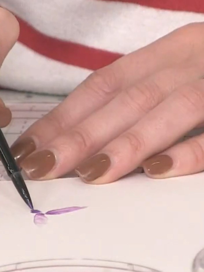 Step 4: Whilst the paint is still wet, add more concentrated purple colour to the damp area using your brush. This bui