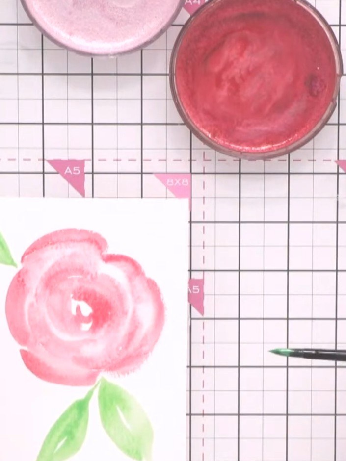 Step 8: Once the watercolour flower and leaves are completely dry, add gold splats or accent marks to enhance the desi