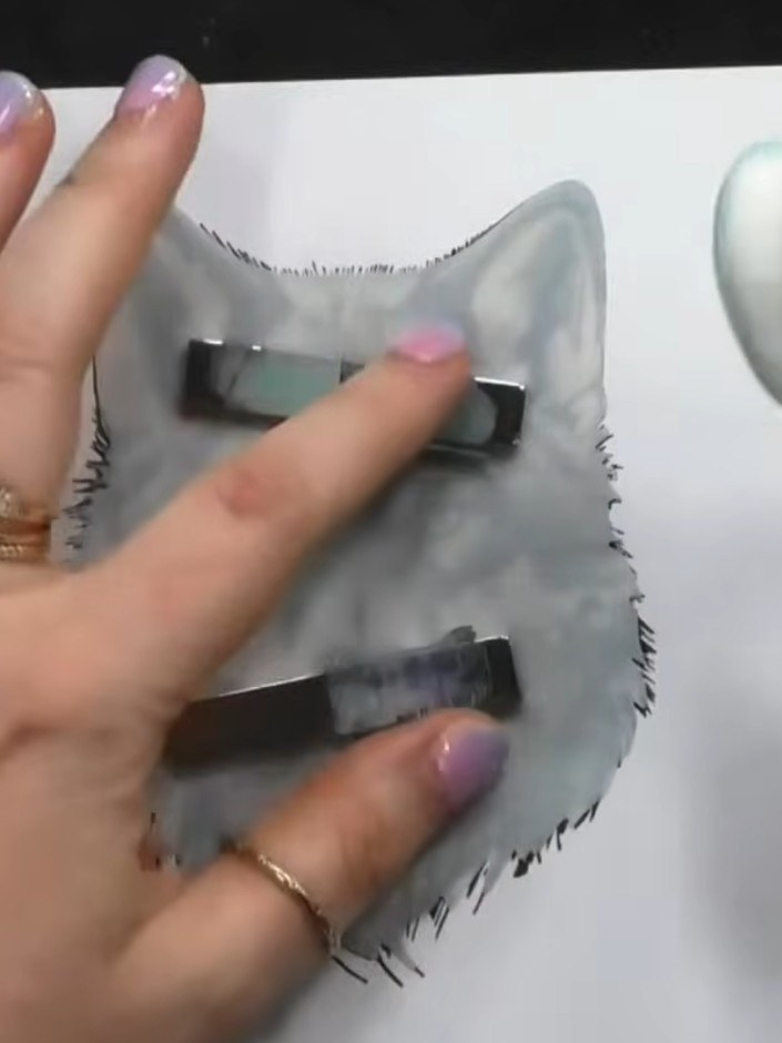 Step 3: Position the grey wolf mask over the coloured wolf image to protect it from further inking. Ensure the mask al