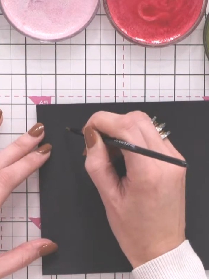 Step 3: Press the full belly of the brush loaded with green ink onto the black cardstock to create the widest part of 